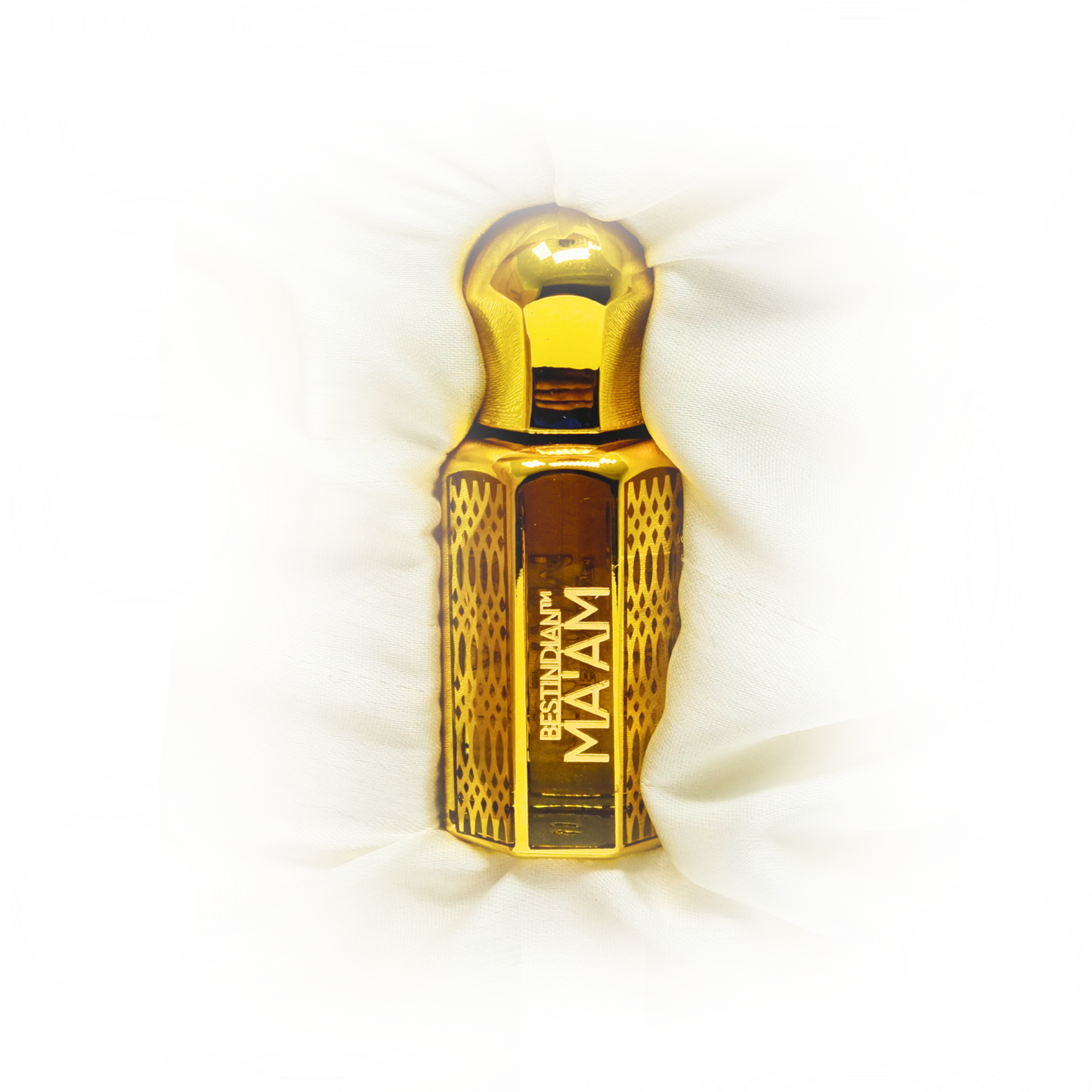 Ma'am luxury perfume oil in its elegant golden vial, creamy white background. Best Indian Perfumes.