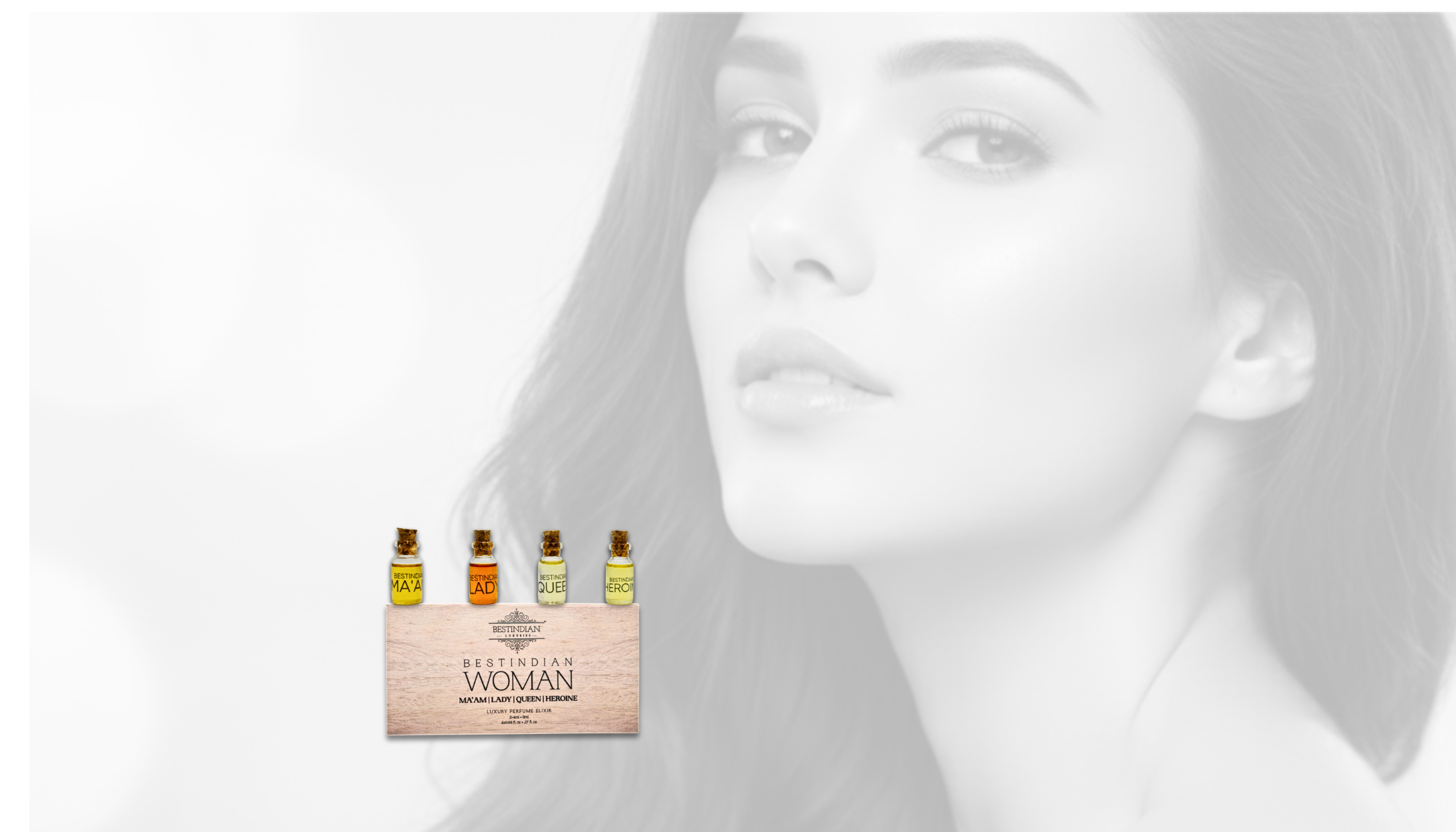 Woman with a set of miniature BestIndian perfume elixir bottles and packaging on a light background