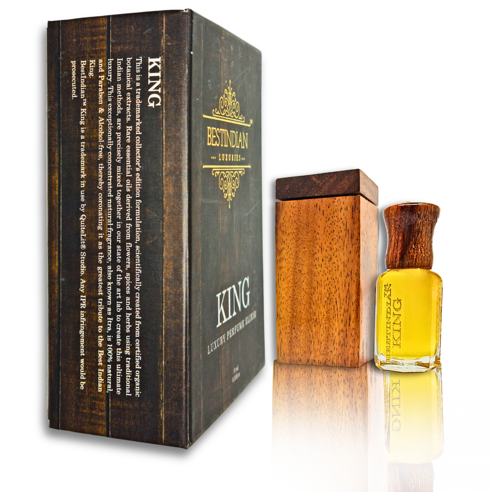 Perfume of the first rain- King by BestIndian™ Petrichor attar elixir vial (wooden cap) with its handcrafted wooden case and dark wood-themed outer box, placed on reflective surface.