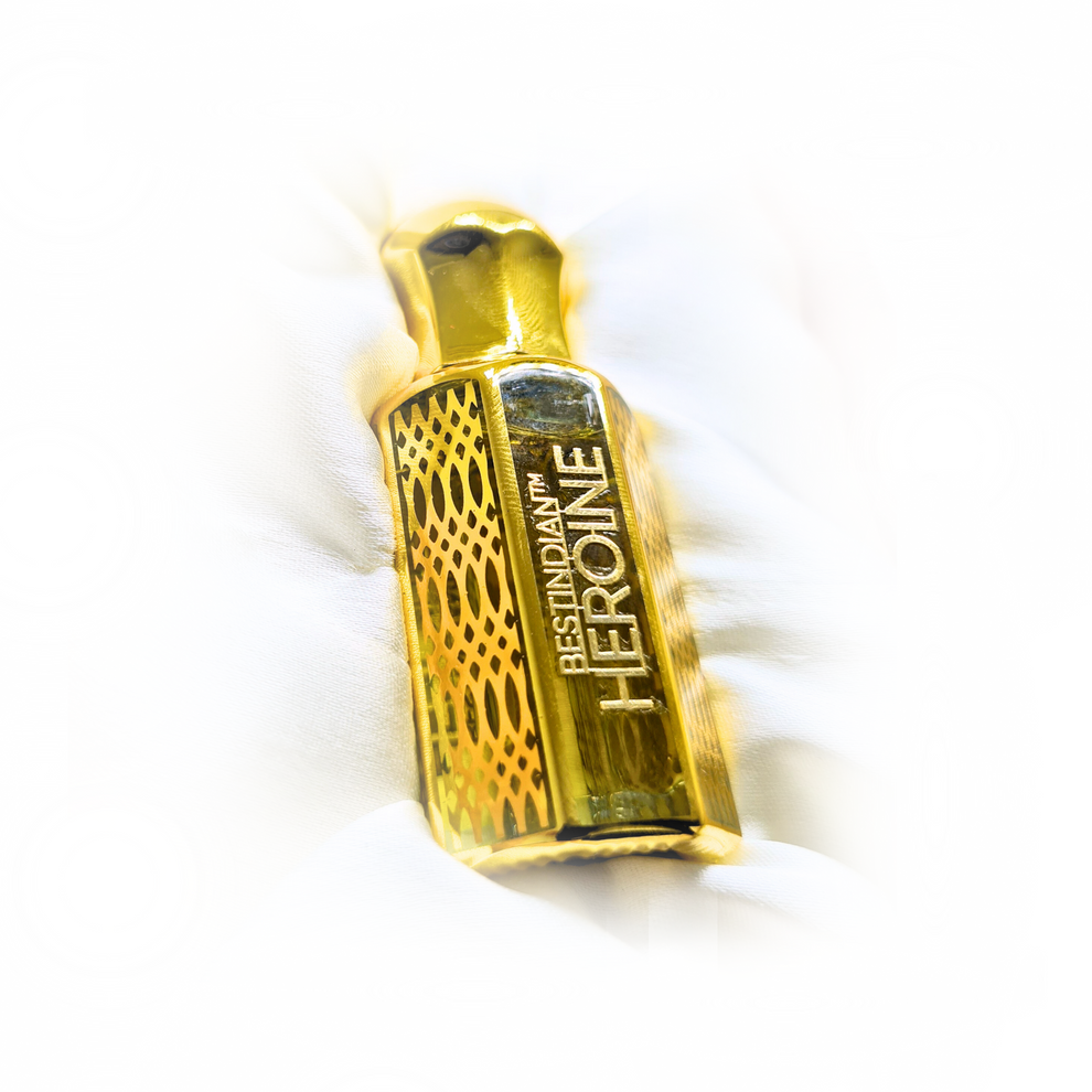 BestIndian™ Heroine tobacco and vanilla attar — close-up of gold perfume bottle on satin cushion.