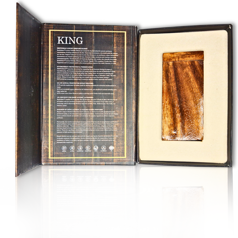 Dark brown wood themed outer packaging box opened to reveal the handcrafted wooden case of King Petrichor attar- perfume of the first rain, in which the glass bottle of the attar is kept.