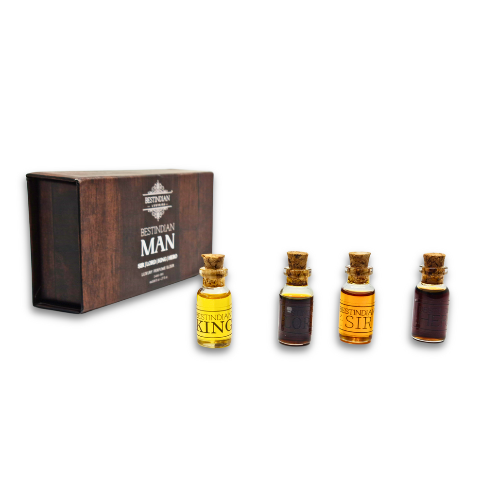 Miniature perfume set featuring four 2ml attar dab-on vials – King, Sir, Hero, and Lord, with their dark wooden-themed packaging in the background.