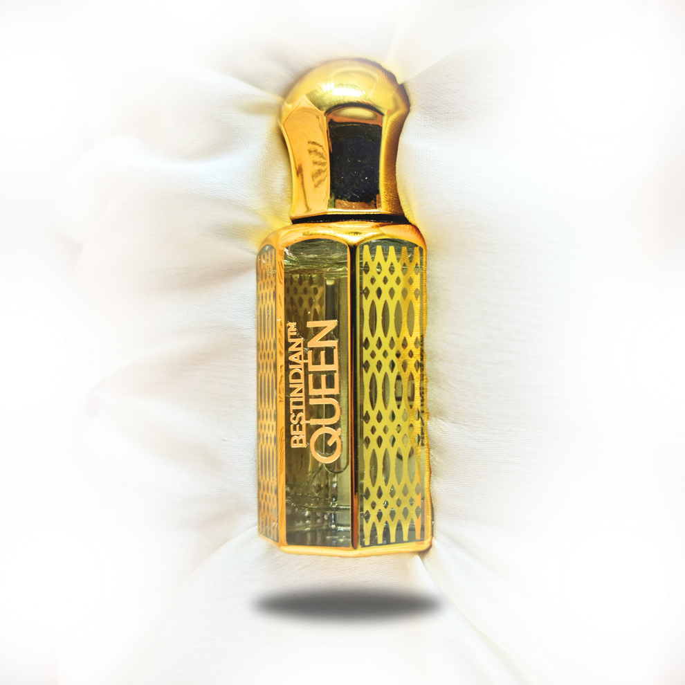 A sophisticated close-up of BestIndian™ Queen golden bottle featuring intricate lattice design, showcasing this regal oud rose attar with elegant woody oriental notes, presented on luxurious satin backdrop highlighting its handcrafted Kannauj oud attar heritage.