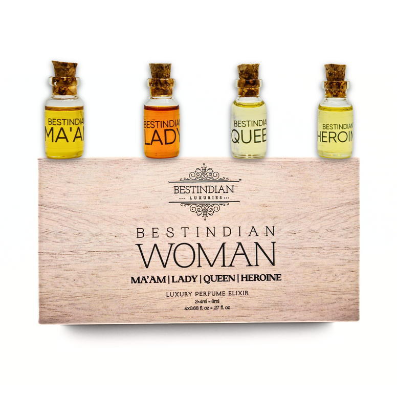Four transparent miniature vials of Best Indian Woman Perfume Oil Elixir Set arranged on their light wooden-themed packaging box. 100% Natural Perfumes for her.
