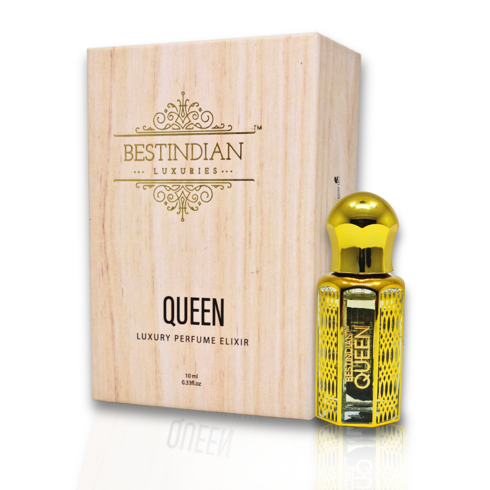 Complete presentation of BestIndian™ Queen featuring ornate golden roll-on bottle positioned alongside its luxury wooden box, highlighting this handcrafted Kannauj oud attar with sophisticated woody oriental fragrance profile perfect for the discerning woman.